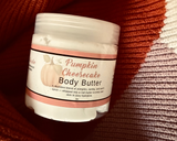 Jar of Pumpkin Cheesecake body butter on a textured brown background